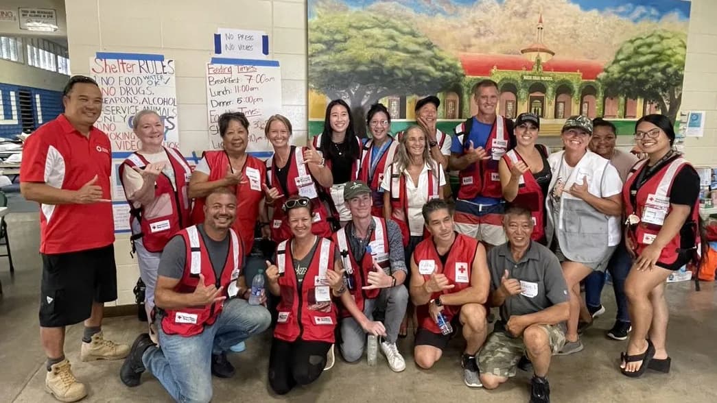 American Red Cross volunteers posing together inside a community relief shelter